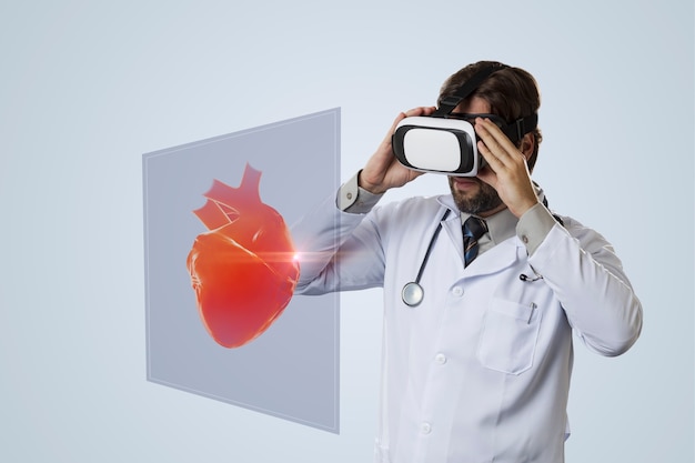 Foto médico usando óculos de realidade virtual, olhando para um coração virtual.