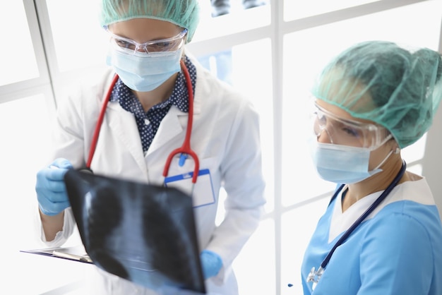 Los médicos de la clínica están mirando una radiografía de los pulmones.