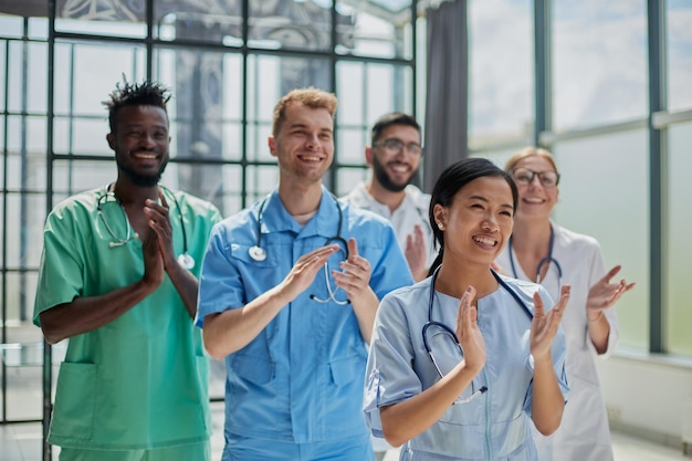 Médicos multinacionales profesionales aplaudiendo frente a la cámara Discusión de diagnóstico