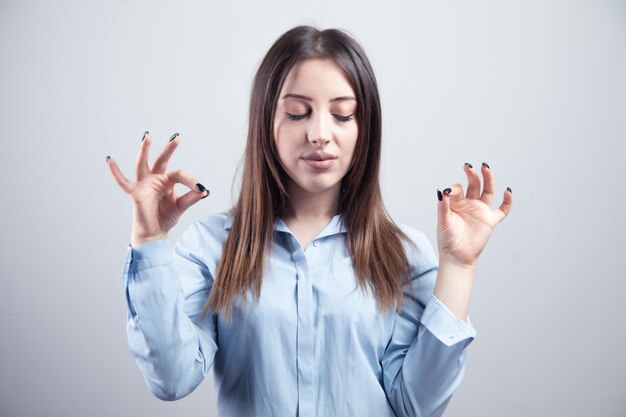 Meditationskonzept. Schöne junge Frau steht in meditativer Pose