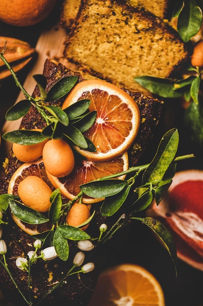 Mediterraner Zitrus-Laibkuchen mit frischen Früchten und blühenden Blumen