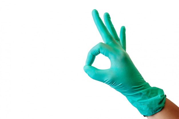Medizinische Handschuhe des blauen Latex auf einer weiblichen Hand