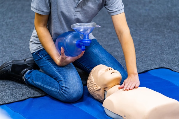 Medizinisches Verfahren zum HLW-Training. Demonstration von Brustkompressionen an einer CPR-Puppe in der Klasse.