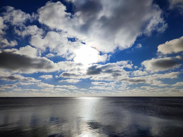 Meereshorizont mit Sonne, die sich im schimmernden blauen Meer spiegelt