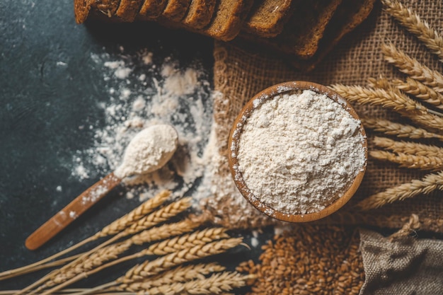 Mehl in einer Holzschüssel, frisches hausgemachtes Brot und Maiskörner, Banner der Bäckerei
