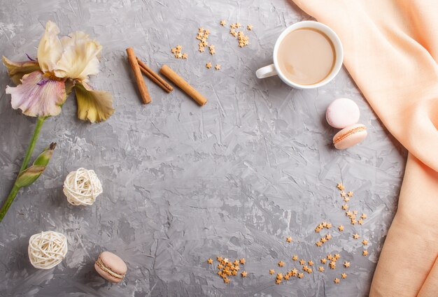 Mehrfarbige Irisblumen und ein Tasse Kaffee auf grauem Beton