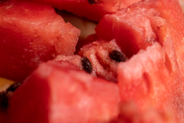 Melancia vermelha madura cortada em pedaços deliciosa melancia de frutas vermelhas com sementes marrom-pretas