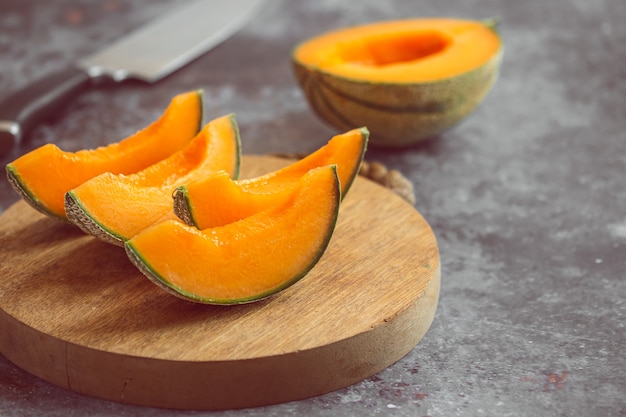 Melão de laranja doce fresca na placa de madeira