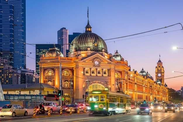 Melbourne Flinders Street Train Station mit fahrender Straßenbahn in Australien bei Sonnenuntergang