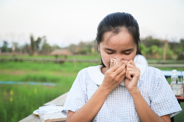 Menina asiática com sensação de febre fria da doença para o conceito de vírus Corona