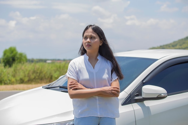 Menina asiática em frente ao carro na rua