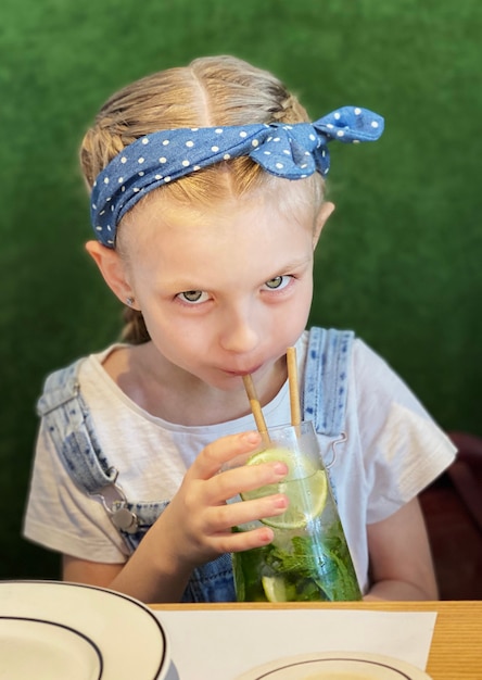 Menina bebendo mojito sem álcool em um café