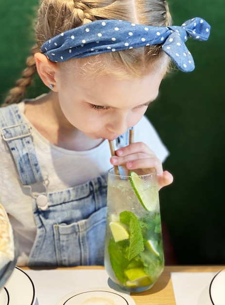 Menina bebendo mojito sem álcool em um café