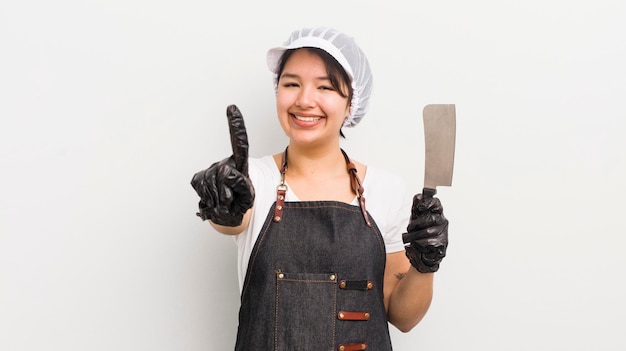 Menina bonita hispânica sorrindo com orgulho e confiança, fazendo o conceito de açougueiro número um