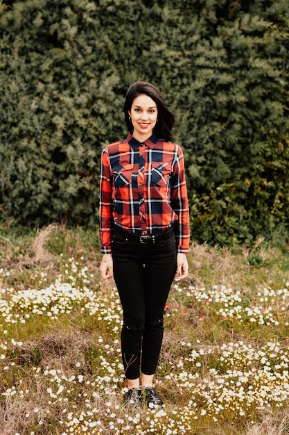 Menina bonita morena com camisa xadrez vermelha