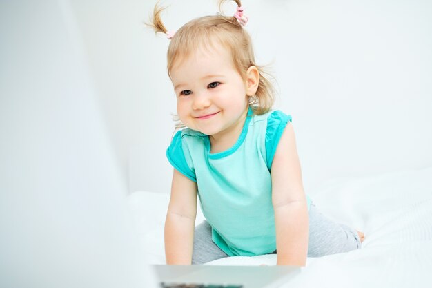 Menina bonitinha brincando em um laptop