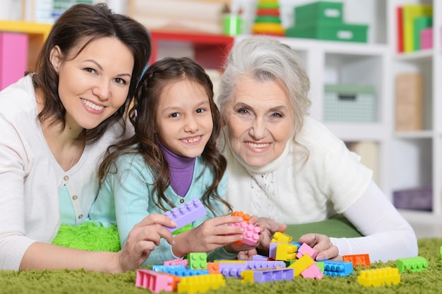 Menina brincando com a mãe e a avó