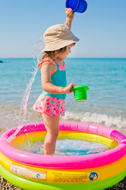 Menina brincando com brinquedos de férias de praia