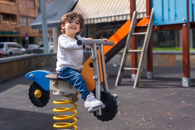 Foto menina brincando em um playground com a forma de uma bicicleta