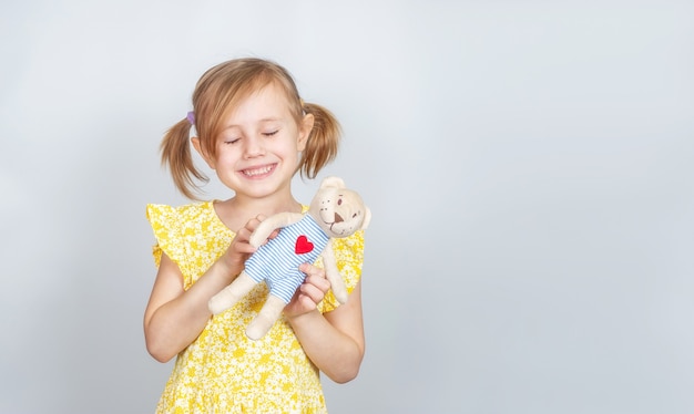 Foto menina caucasiana com ursinho de pelúcia e olhos fechados