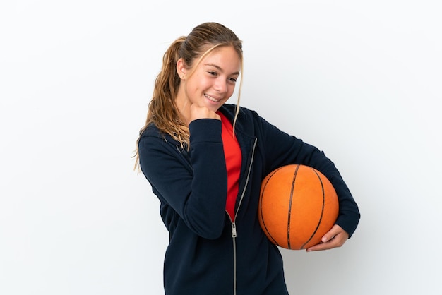 Menina caucasiana isolada no fundo branco jogando basquete