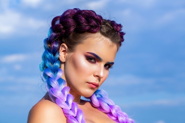 Menina colorida kanekalon trançado em seu cabelo mulher bonita colorido ombre violeta cabelo e maquiagem profissional menina tranças em fundo céu maquiagem brilhante tranças cor-de-rosa pigtails penteado