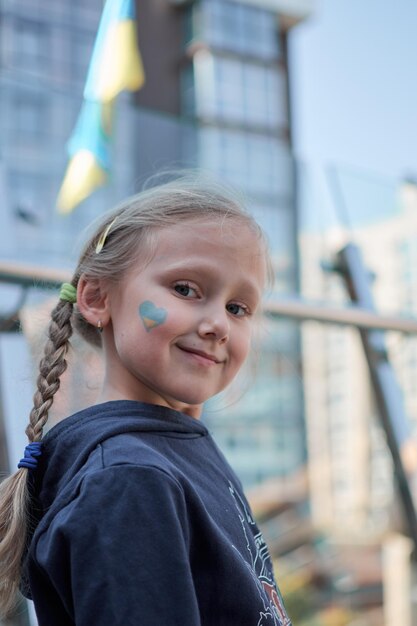 Foto menina com bandeira da ucrânia pintada de amarelo e azul pare a guerra e o poder do patriotismo da ucrânia