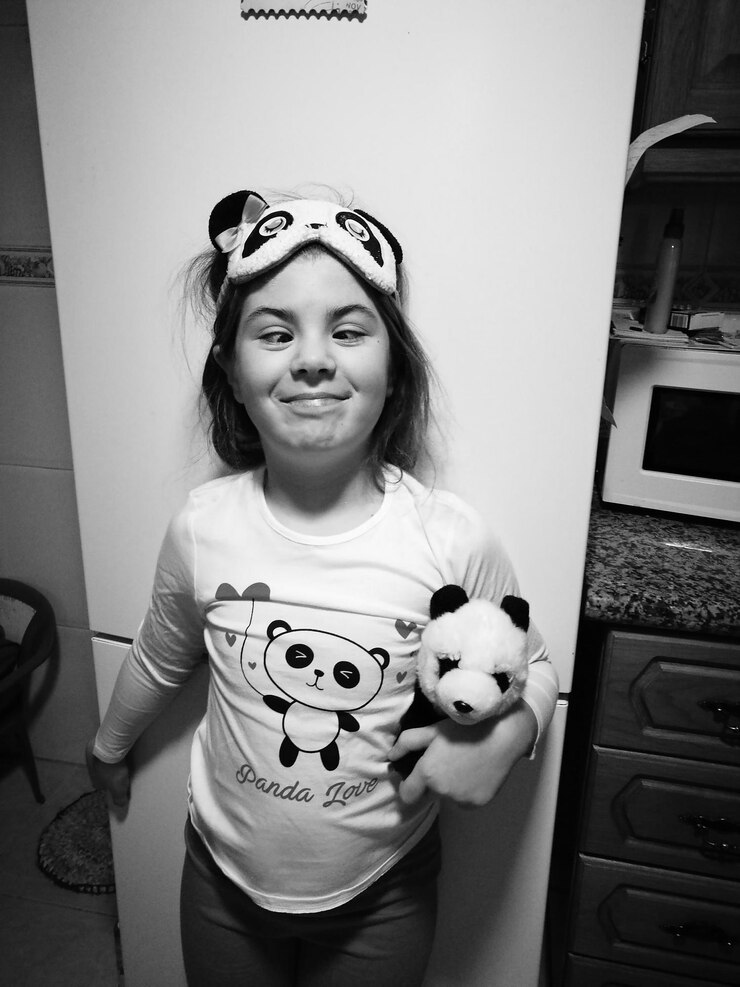 Foto menina com brinquedo de pelúcia em casa