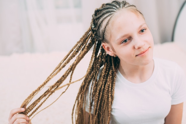 Menina com cabelo castanho e rabo de cavalo trançado com cabelo artificial