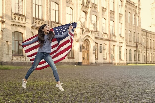 Foto menina com fundo de arquitetura ao ar livre da bandeira americana descobre o conceito dos eua