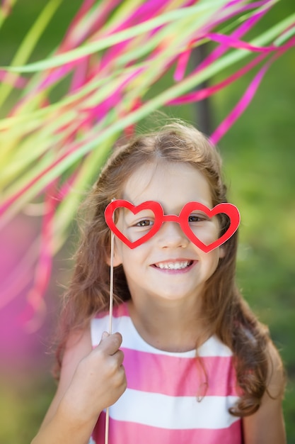 Menina com óculos de papel engraçado