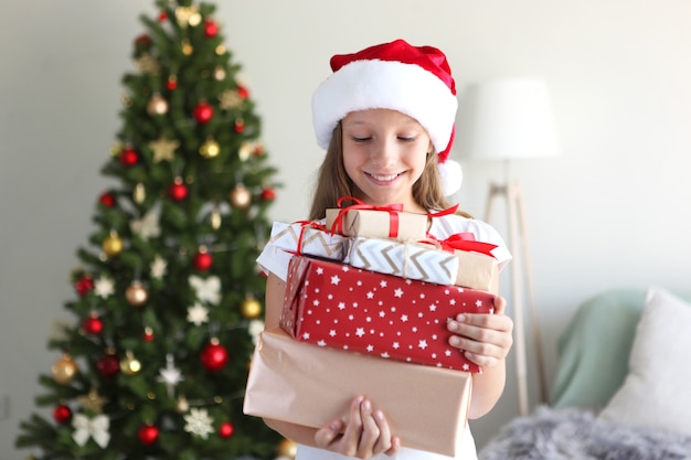 Menina com presentes de natal no interior do natal