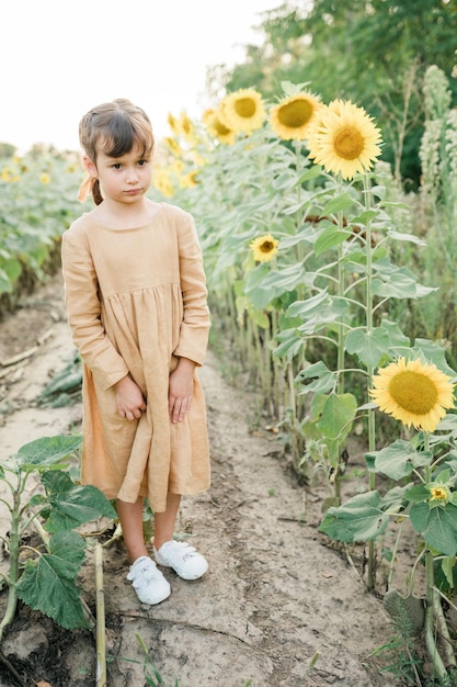 Menina criança feliz no campo de girassóis