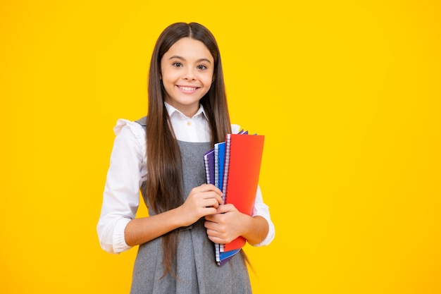 Menina da escola adolescente com fundo de estúdio isolado de livros