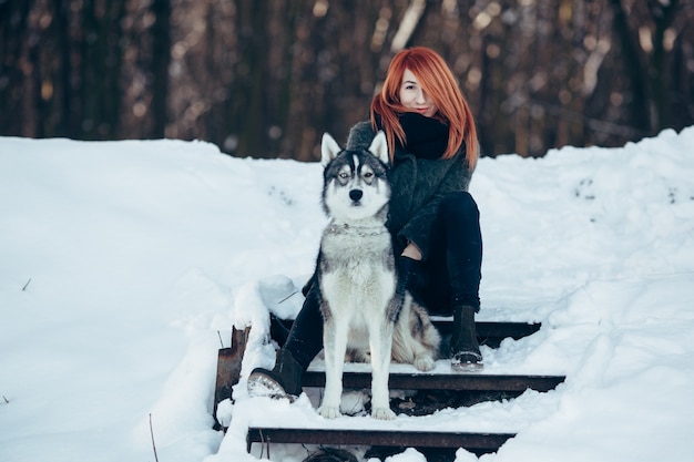 menina de cabelo vermelho com um cachorro