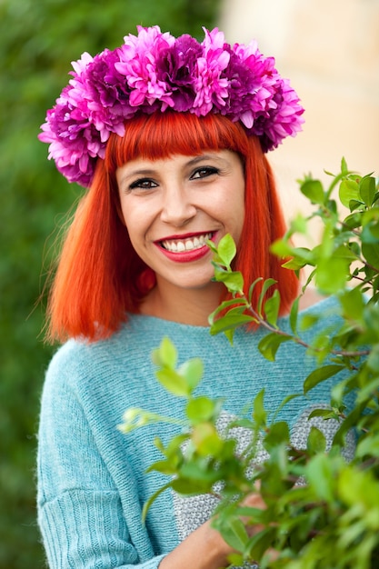 Menina de cabelos vermelha atraente com coroa de flores