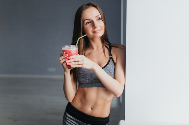 Menina de fitness bebendo suco de fruta