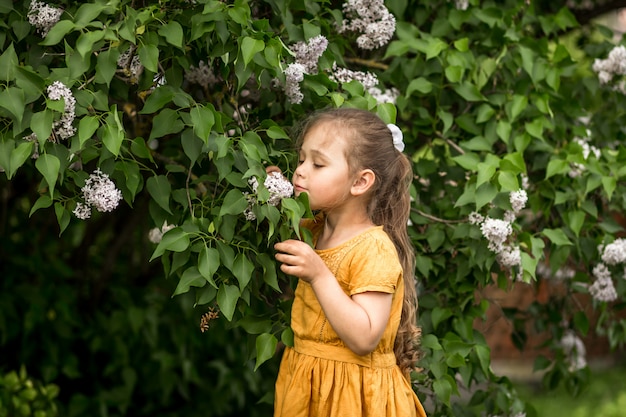 menina e lilás flores no jardim no verão