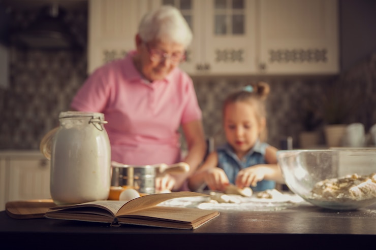 Menina e sua avó cozinhando na cozinha