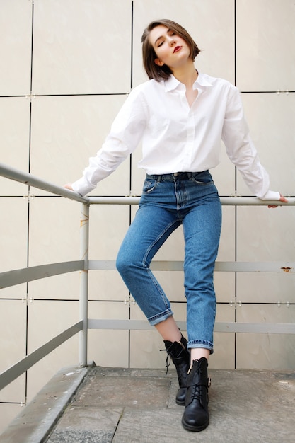 Foto menina elegante em jeans vintage e camisa branca