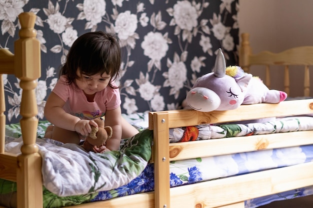 menina em seu quarto brincando com seus brinquedos e bichos de pelúcia