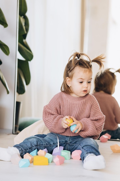 Menina joga brinquedos na sala de estar Brinquedo de madeira Montessori pirâmide dobrada Círculo triângulo retângulo elementos de madeira de brinquedos infantis brinquedo colorido azul amarelo vermelho verde