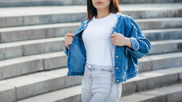 Menina morena elegante vestindo camiseta branca e óculos posando contra o estilo de roupas urbanas de rua