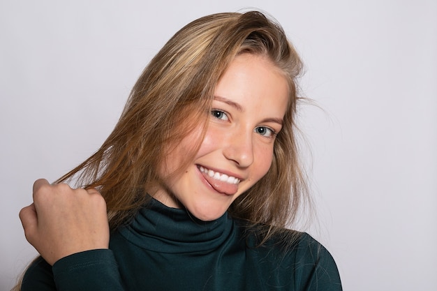 Menina na moda linda hippie. Foto de uma jovem simpática positiva em meias verdes até o joelho com fundo branco. olha para a câmera.