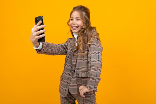 Menina no estilo clássico faz selfie no telefone na