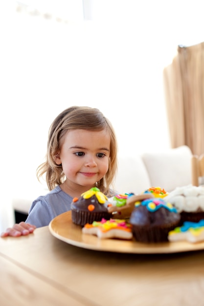 Menina olhando confeitaria em casa