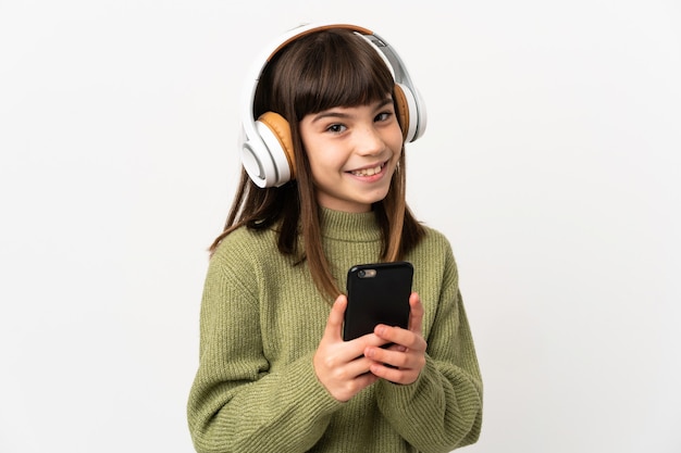 Menina ouvindo música com um celular isolado no branco ouvindo música com um celular e olhando para a frente