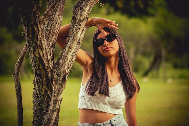 Menina pequena posando na paisagem verde