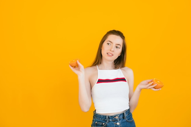 menina pura com dois pedaços de laranja