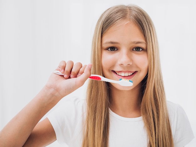 Foto menina se preparando para escovar os dentes